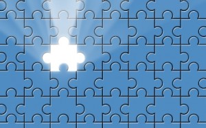 Blue puzzle with missing piece and light beam