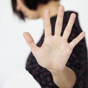 Woman stop talking hand gesture